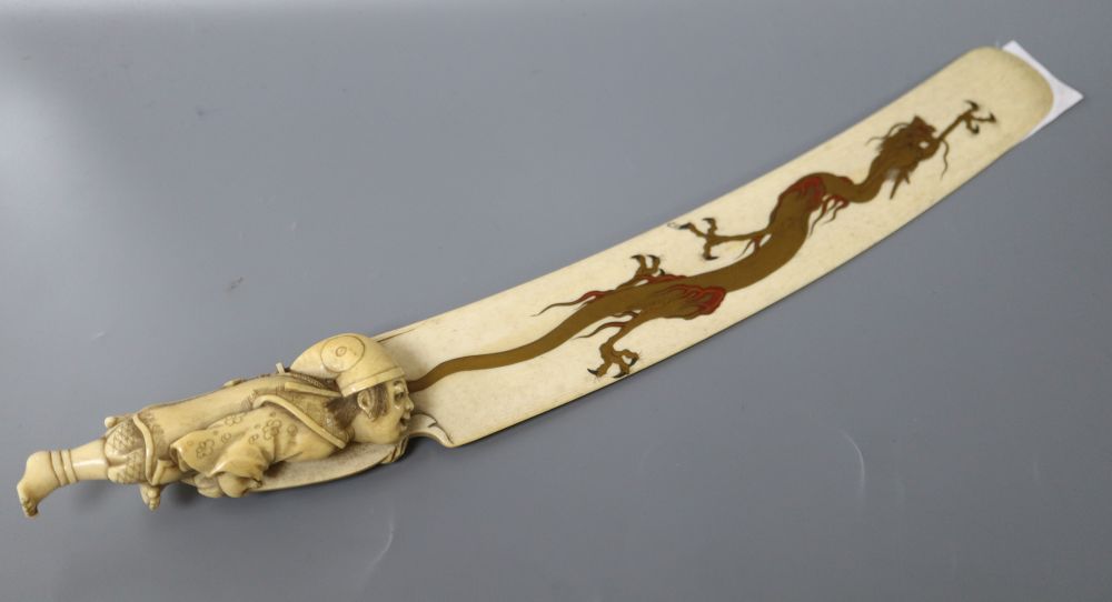 A carved ivory letter opener, with hand painted enamel gilt dragon, length 34cm